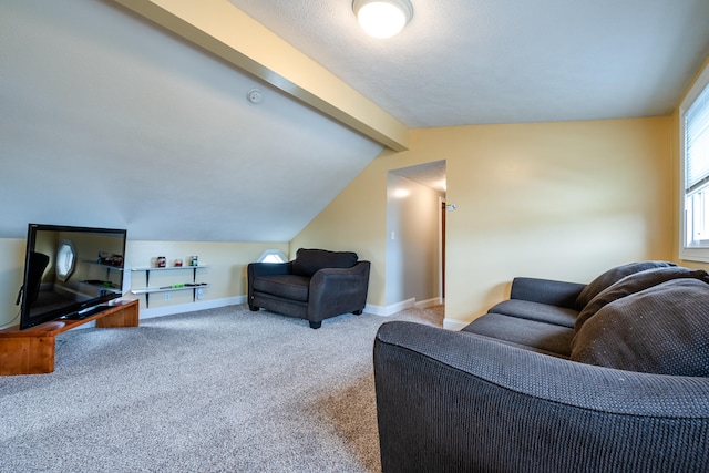 carpeted living room featuring vaulted ceiling with beams