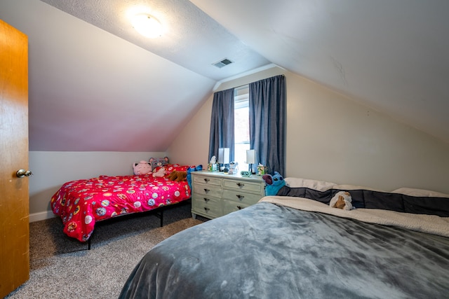 carpeted bedroom with vaulted ceiling and a textured ceiling