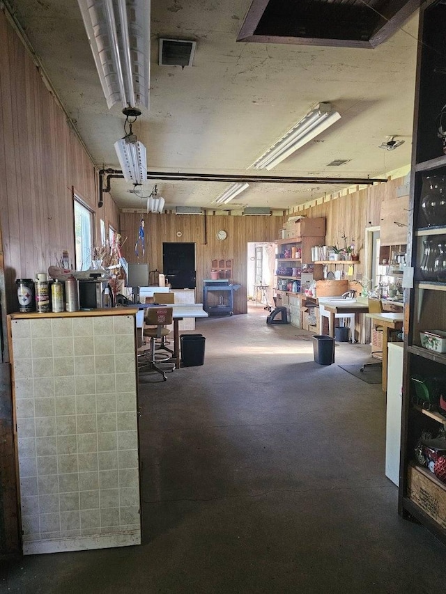 miscellaneous room featuring wooden walls