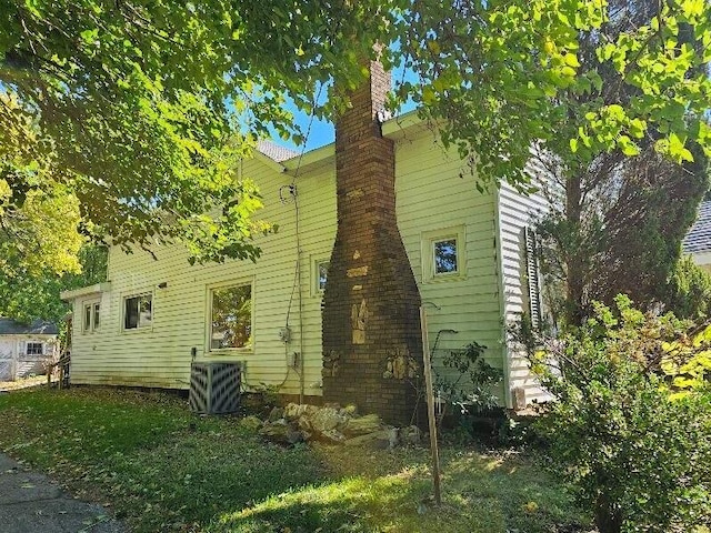 view of side of home featuring central AC