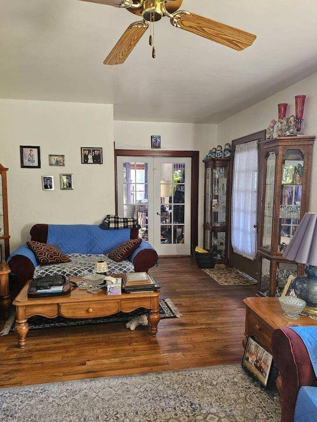 living room featuring dark wood-type flooring, ceiling fan, and french doors