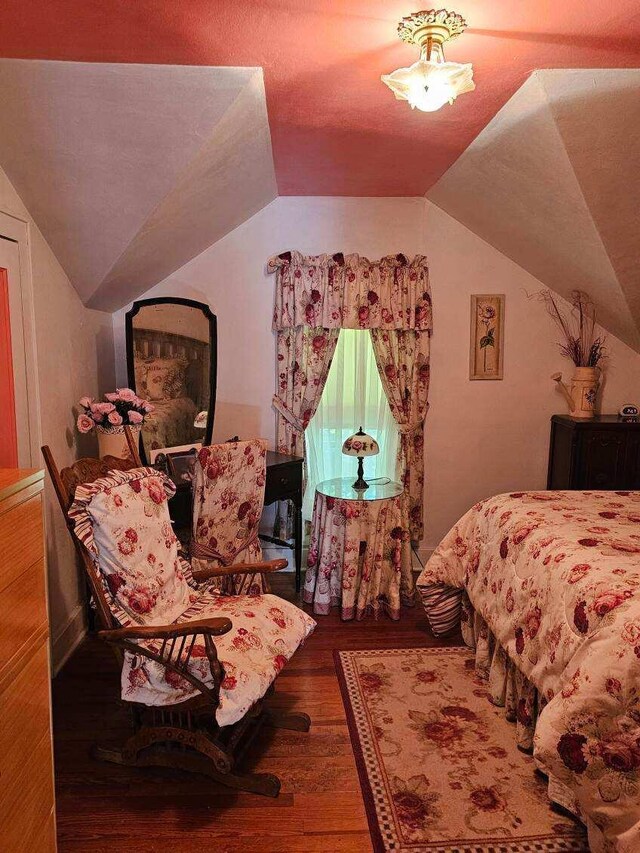 bedroom featuring hardwood / wood-style floors and vaulted ceiling