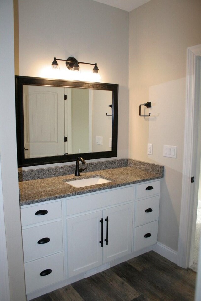 bathroom with vanity and wood-type flooring