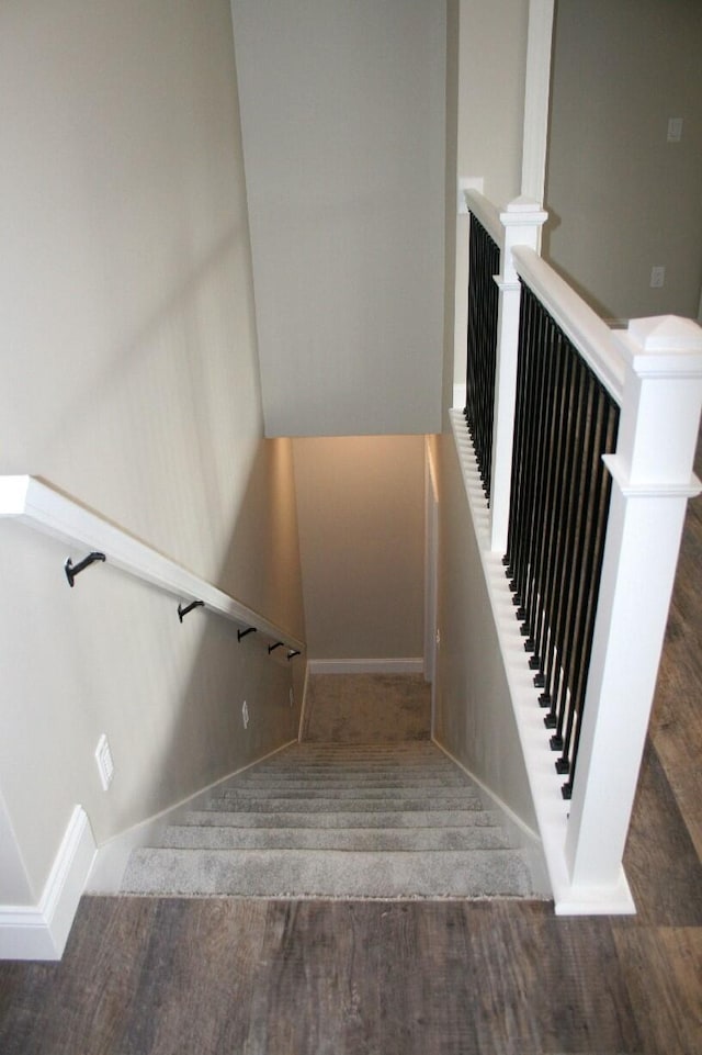 stairs with hardwood / wood-style floors