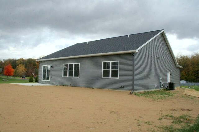 back of property featuring central AC