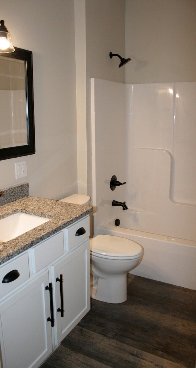 full bathroom featuring vanity, bathing tub / shower combination, toilet, and hardwood / wood-style flooring