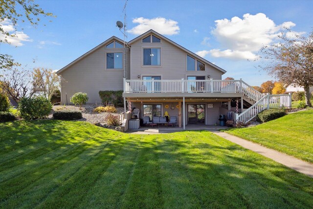 back of house featuring a patio area, a deck, and a lawn