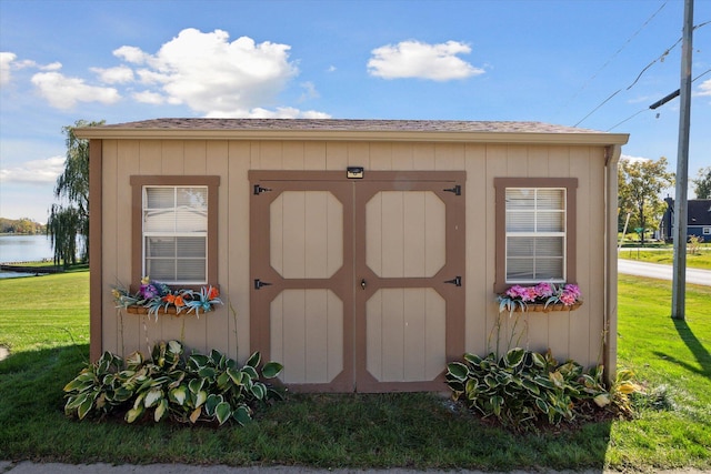 view of outdoor structure featuring a yard and a water view