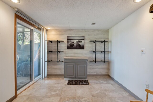 bathroom featuring vanity and wooden walls