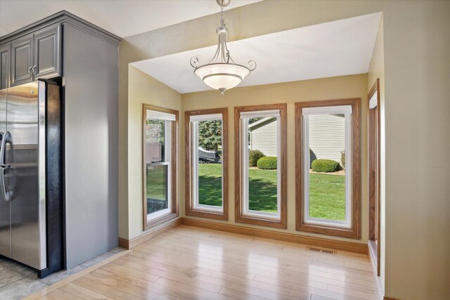 interior space featuring lofted ceiling and light wood-type flooring