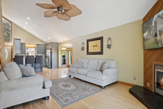 living room with light hardwood / wood-style floors, plenty of natural light, and ceiling fan