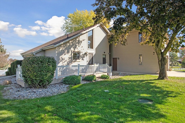 exterior space featuring a deck and a lawn