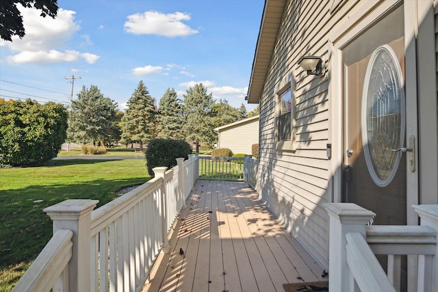 wooden terrace with a lawn