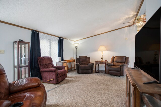 living room featuring ornamental molding, a textured ceiling, carpet flooring, and ceiling fan