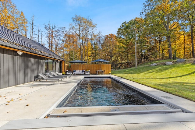 view of pool featuring a patio area and a lawn