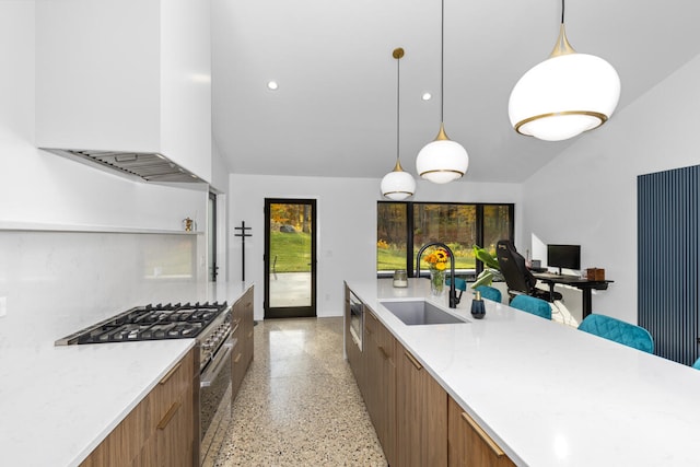 kitchen featuring stainless steel range, wall chimney exhaust hood, sink, and pendant lighting