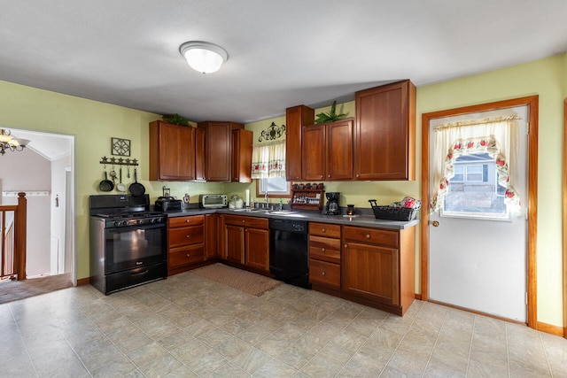 kitchen with sink, black appliances, and a chandelier