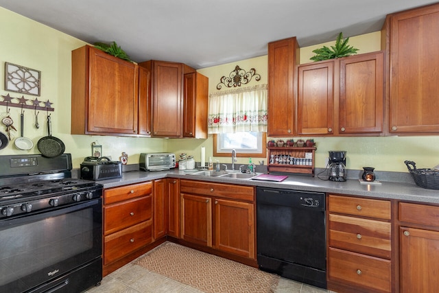 kitchen featuring light tile patterned flooring, black appliances, and sink