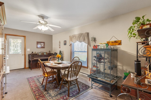 dining room with baseboard heating, carpet, and ceiling fan