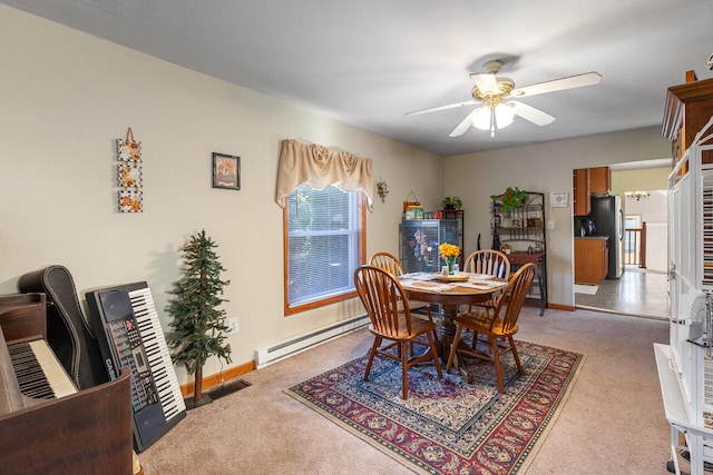 carpeted dining area with a baseboard radiator and ceiling fan