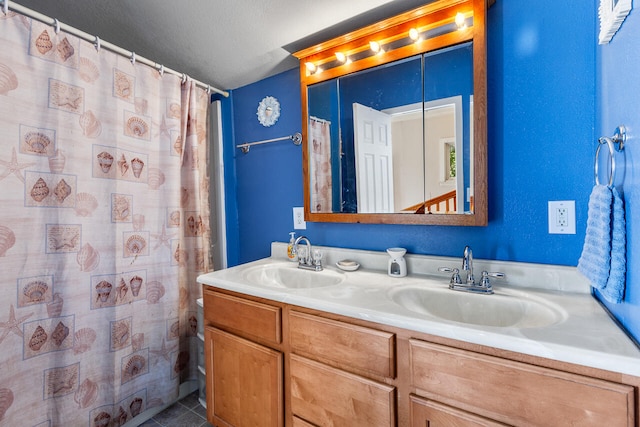 bathroom featuring vanity, tile patterned floors, a textured ceiling, and walk in shower