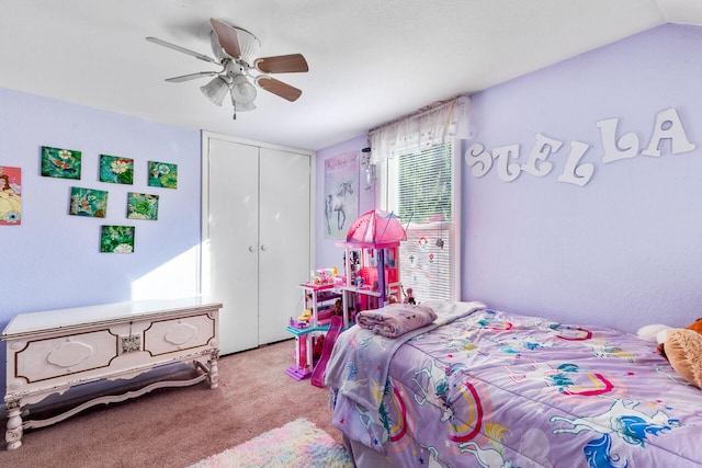 carpeted bedroom with a closet, ceiling fan, and lofted ceiling