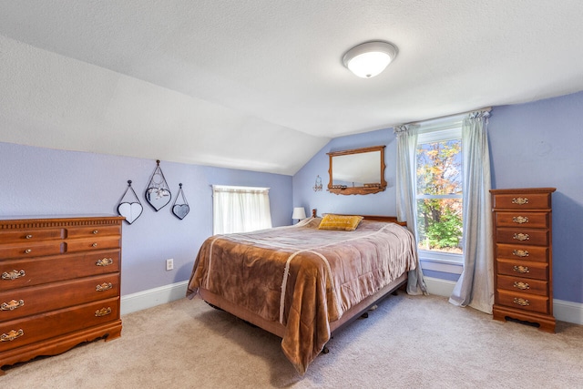 bedroom with light carpet, a textured ceiling, and vaulted ceiling