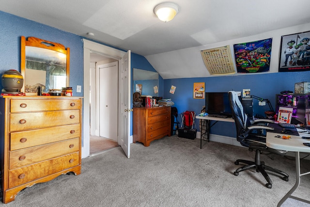 office area with vaulted ceiling and light carpet