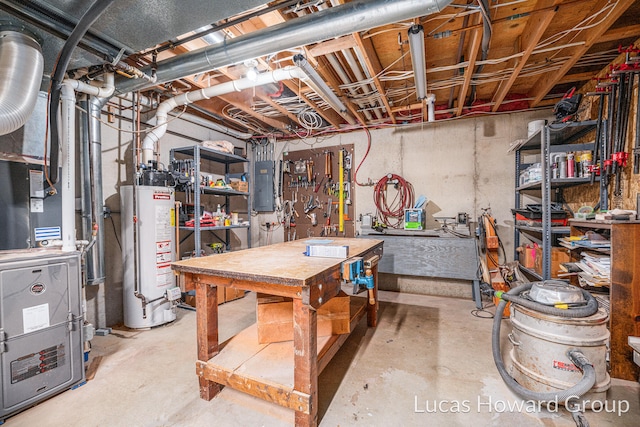 basement featuring heating unit, electric panel, and gas water heater