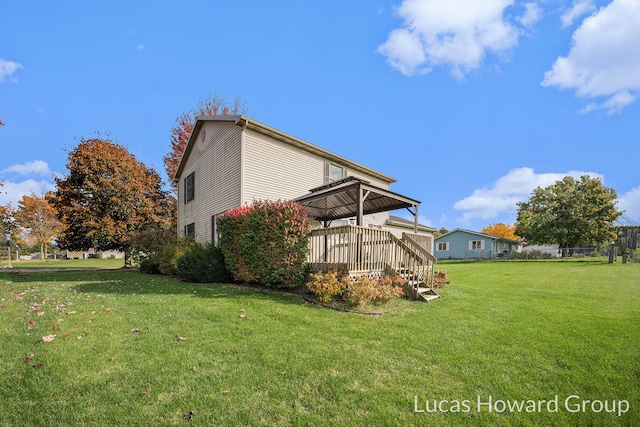 view of property exterior featuring a yard and a wooden deck