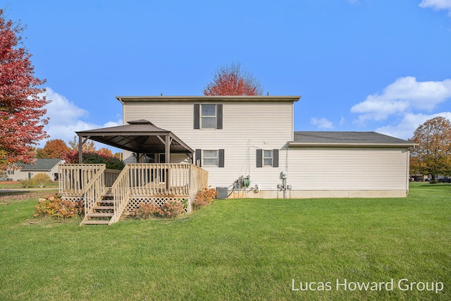 back of house featuring a yard and a wooden deck