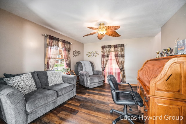 home office featuring dark hardwood / wood-style floors and ceiling fan