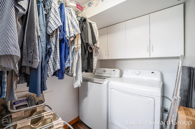 washroom featuring hardwood / wood-style floors, washer and dryer, and cabinets