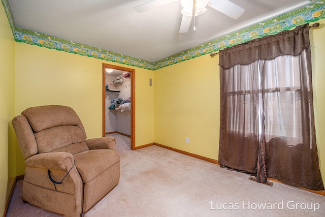 sitting room featuring carpet flooring and ceiling fan