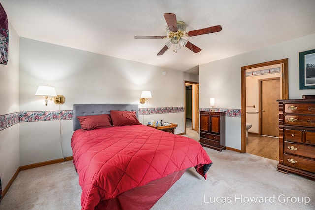 bedroom with connected bathroom, ceiling fan, and light carpet