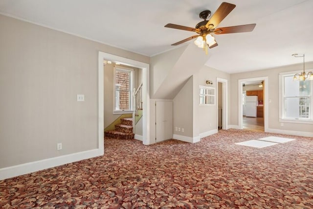 bonus room with carpet floors, a healthy amount of sunlight, and ceiling fan with notable chandelier