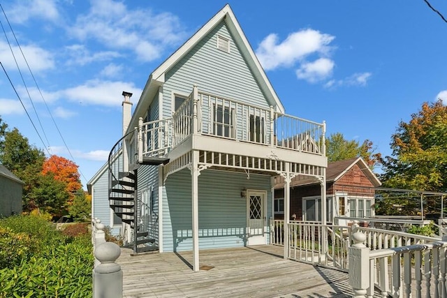 rear view of property featuring a deck