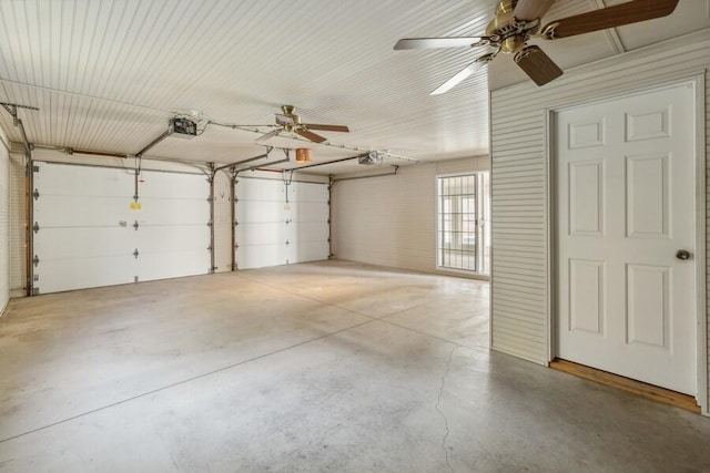 garage with ceiling fan and a garage door opener