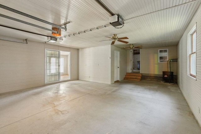 garage featuring ceiling fan and a garage door opener