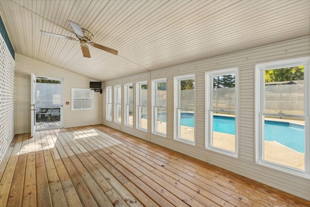 unfurnished sunroom featuring ceiling fan and vaulted ceiling