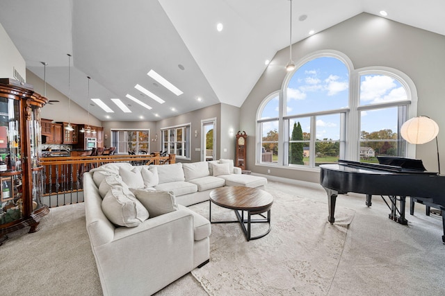 carpeted living room featuring high vaulted ceiling and plenty of natural light