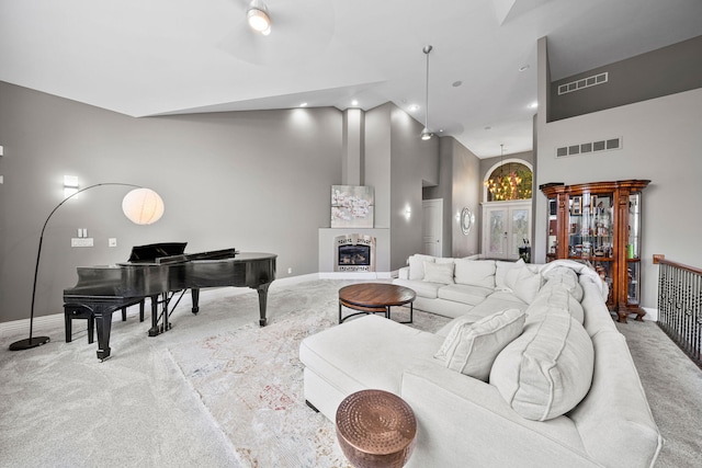 carpeted living room featuring a high ceiling