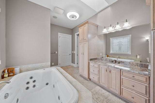 bathroom with vanity, a skylight, a bathtub, and tile patterned floors