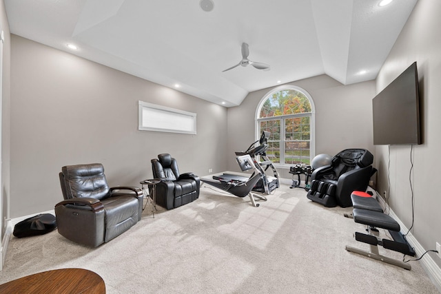 workout area featuring ceiling fan, lofted ceiling, and light colored carpet