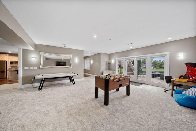 recreation room with french doors and light carpet