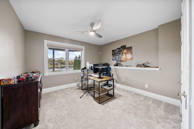 office space with ceiling fan and light colored carpet