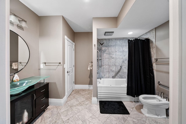 bathroom featuring vanity, shower / bath combo, and a bidet