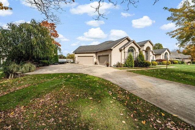 view of front facade with a garage and a front lawn