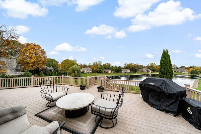 wooden deck featuring grilling area and a water view