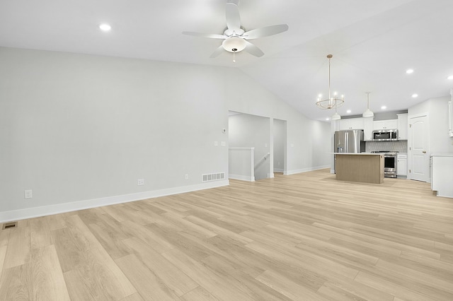 unfurnished living room with ceiling fan with notable chandelier, light hardwood / wood-style floors, and lofted ceiling